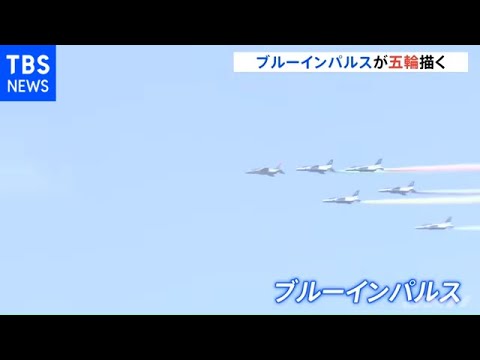 Five-colored ring Blue Impulse flies over the city center on the day of the opening of the Olympics