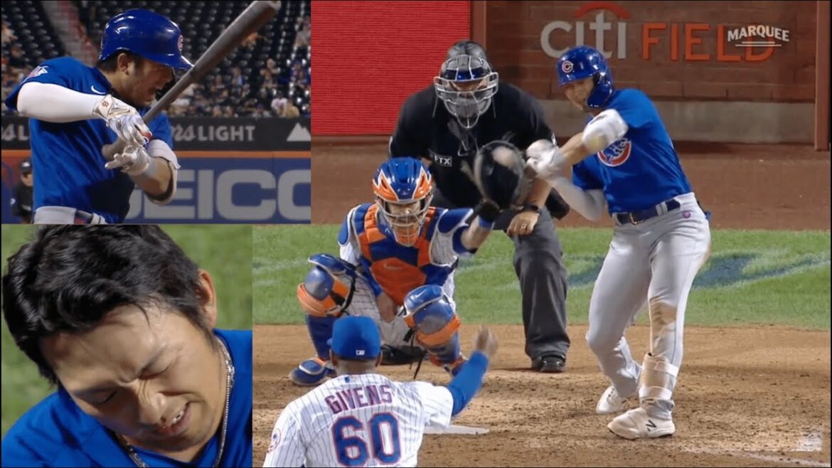 Seiya Suzuki faints in agony after being hit by a pitch near his left hand.