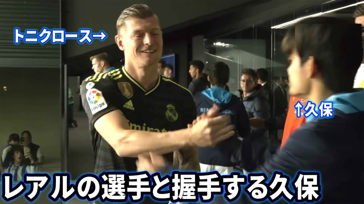 Takefusa Kubo shaking hands with a reunited Real Madrid player